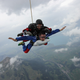 Illustration for article titled Pure Nerd Insanity: Two Men Skydiving with a Girly Hug Pillow
